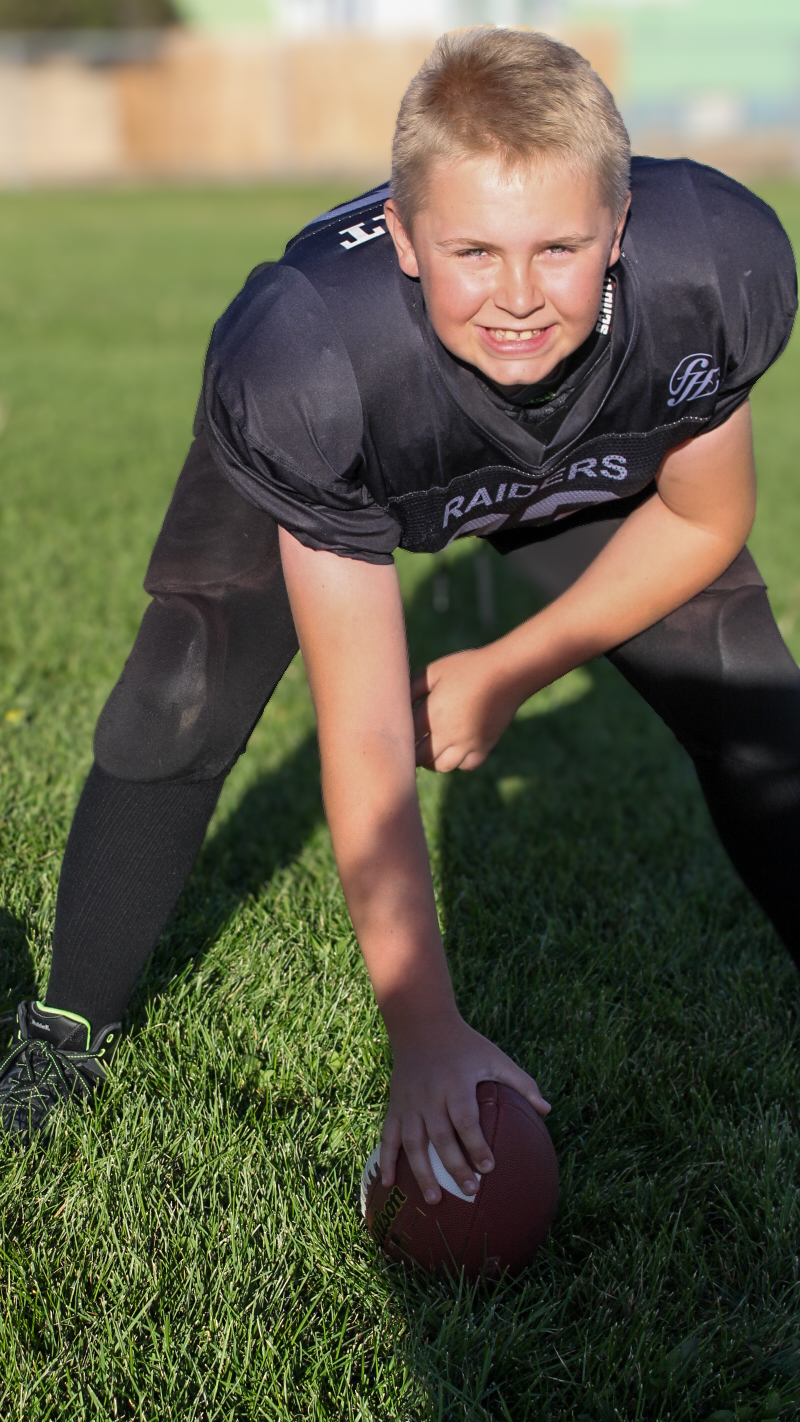 Youth football player with helmet