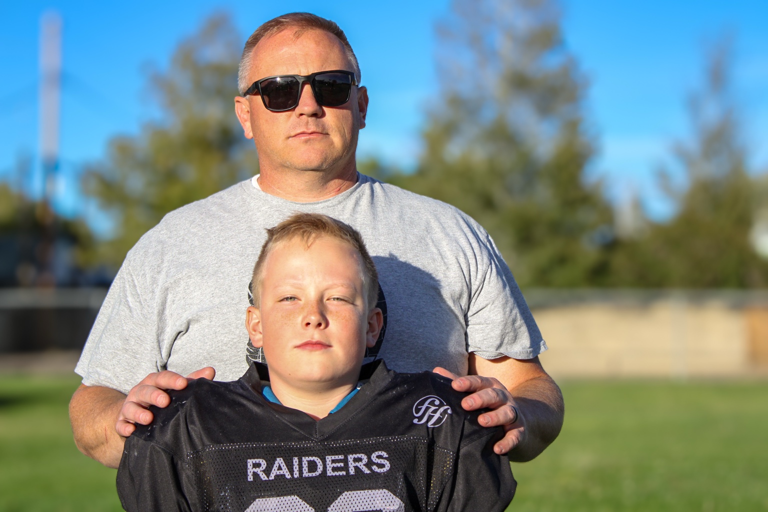 Father with youth Raiders football player