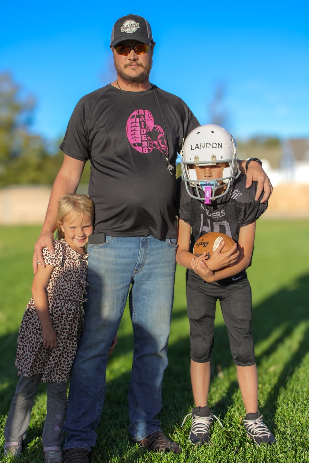 Father with young football player and daughter