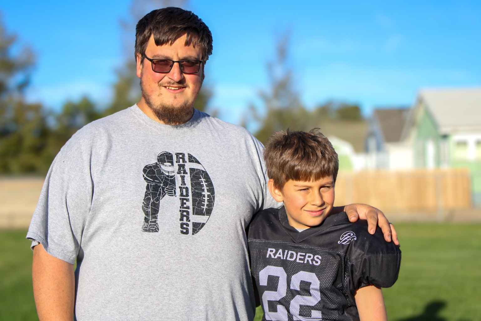 Family member with youth Raiders football player